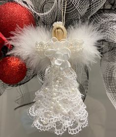 an angel ornament hanging from a christmas tree