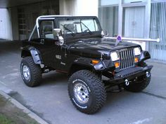 a black jeep parked in front of a building