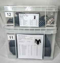 two plastic bins with shirts and ties on top of each other in front of a white background