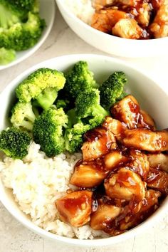 two white bowls filled with rice and broccoli covered in teriyaki sauce