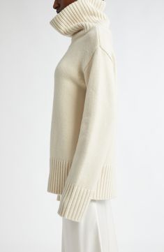 A dramatically oversized turtleneck brings scarf-inspired warmth to this roomy sweater knit from pure cashmere in a pale ivory hue. 27" length (size Large) Turtleneck Long sleeves Dropped shoulders Ribbed cuffs and hem 100% cashmere Dry clean Imported Designer Clothing Classic Chunky Knit Cashmere Sweater, Classic Cashmere Sweater With Chunky Knit, Beige Chunky Knit Cashmere Sweater, Classic Cashmere Chunky Knit Sweater, Cream Turtleneck With Ribbed Cuffs, Beige Cashmere Sweater With Chunky Knit, Classic Oversized Beige Sweater, Oversized Classic Beige Sweater, Classic White Turtleneck With Ribbed Cuffs