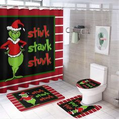 a bathroom decorated in red and green with the grin on it's shower curtain