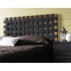 a bed with a wooden headboard and pillows