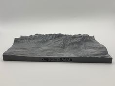 a sculpture of a mountain range with the name zugspitze 9 - 7171 on it