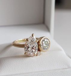 an engagement ring with two pear shaped diamonds