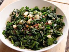 a white bowl filled with lots of green vegetables