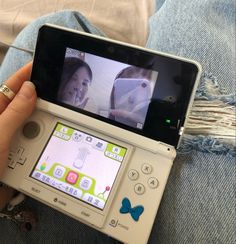 a person holding a cell phone with a video game on the screen