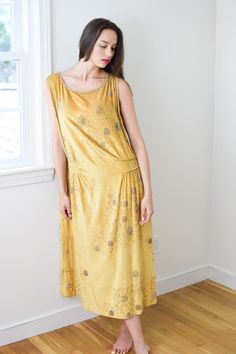 "antique 1920s vibrant citrine yellow silk velvet with all-over silver beaded \"bubble\" motif. tabard-style deep armholes, piped and gathered accents at the dropped waist. hooks-and-eyes close the top of the left shoulder. a rare and special example of 1920s finery. label: M-------'s Gowns, Paris France. sadly the label has deteriorated and made the maker's name difficult to read. someone may yet be able to solve it though! approx size: medium/large (should have a loose/draped fit) model wears Velvet Gown, Yellow Silk, High Hips, Silk Velvet, Vintage Hairstyles, Dress Clothes For Women, Yellow Dress, Summer Looks, Silver Beads