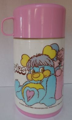 a pink and white coffee cup with a cartoon bear on it