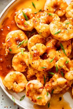 a white plate topped with shrimp and sauce