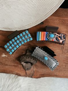 Western Spots and Serape Claw Clip | Gussied Up Online Boutique Experience the ultimate Western style with our Western Spots and Serape Claw Clip! Its textured print and spot serape design, accented with a beautiful turquoise concho stone, will elevate any outfit. With a convenient 3" brown clip, it's the perfect accessory for a bold and stylish look.