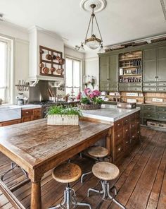 an old fashioned kitchen with wooden floors and green cabinets