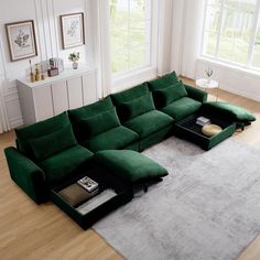 a large green sectional sofa sitting on top of a wooden floor next to a window