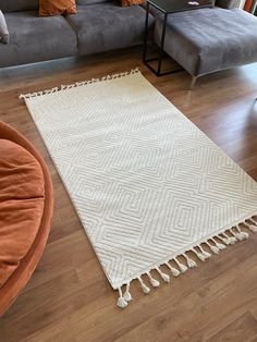 a living room with a couch and rug on the floor