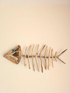 a fish skeleton with eyes on it's side and some branches in the foreground