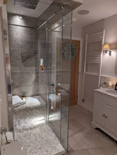 a bathroom with a walk in shower sitting next to a sink and a bathtub