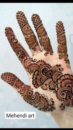 the hand is decorated with henna designs on it