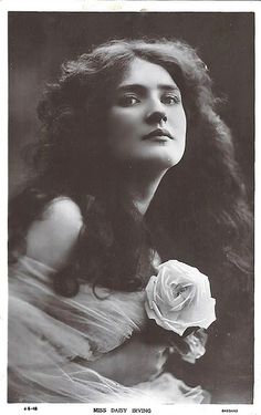 an old black and white photo of a woman holding a rose