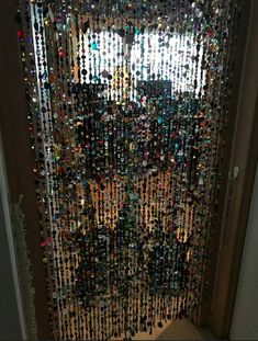 a door covered in lots of different colored beads