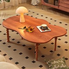 a wooden table with a lamp on top of it in a living room next to a couch