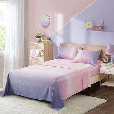 a pink and purple bed in a bedroom