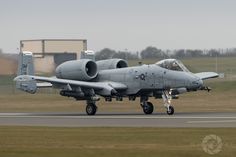 a fighter jet sitting on top of an airport runway