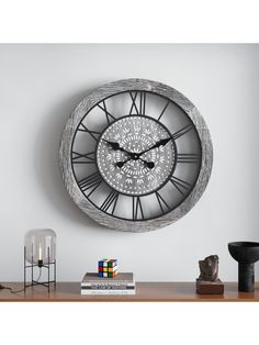 a wall clock with roman numerals on it