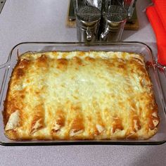 a casserole dish on a counter with utensils