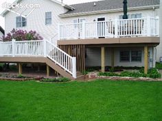 two story house with white balconies and stairs