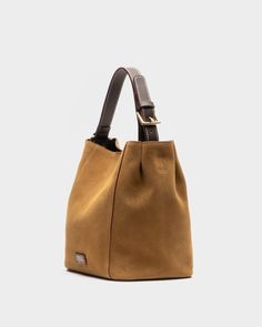 The petite version of one of our best-selling handbags, the Small June offers an effortless slouch silhouette in soft suede that makes carrying essentials as fabulous as everything else in life. Complete with a leather handle, center snap (for keeping secrets safe!), and a detachable crossbody strap—perfect for those "hands-free and fabulous" moments. Slouchy suede hobo tote Leather handle, center snap, & detachable crossbody strap Features unique tea-stained leather edges Back zip pocket with t Suede Bucket Bag, Secret Safe, Keeping Secrets, Unique Tea, Essential Dress, Sale Store, Summer Prints, Handbag Shoes, Soft Suede