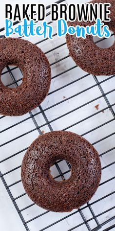 baked brownie doughnuts sitting on top of a cooling rack with text overlay