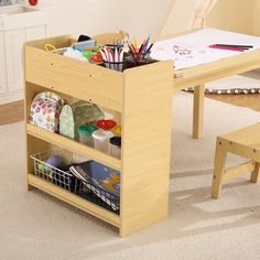 a child's table and bench with toys in it