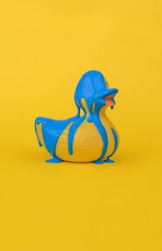 a blue and yellow rubber duck on a yellow background