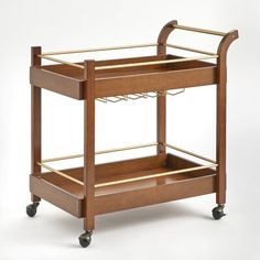 a wooden serving cart with two trays on wheels