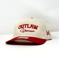 Introducing the 'Outlaw Woman Trucker Hat,' the perfect accessory for women who want to make a statement. This trucker hat is made to last, designed with high-quality materials that can endure any outdoor adventure. The hat features a classic trucker style with a curved brim and adjustable snapback closure, making it comfortable and easy to wear. The black mesh backing ensures ample ventilation, keeping you cool even on hot summer days.The front of the hat boasts an embroidered design of an outlaw woman on horseback, flaunting her fearless spirit and free-spirited nature. The contrasting white stitching adds an extra pop of style.Whether you're hitting the trails or running errands around town, this 'Outlaw Woman Trucker Hat' will elevate your outfit while protecting your face from harmful Cowgirl Trucker Hat, Women Trucker Hat, Embroidered Trucker Hats, Cute Trucker Hats, Western Trucker Hats, Woman On Horseback, Trendy Trucker Hats, Golf Fits, Red Trucker Hat