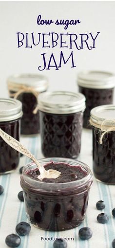 blueberry jam in glass jars with spoons on striped cloth and text overlay reading low sugar blueberry jam