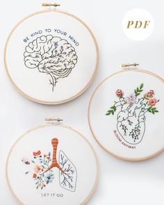 three embroidery hoops with embroidered designs on them and the words be kind to your mind, let it go