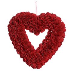 a heart made out of red roses on a white background