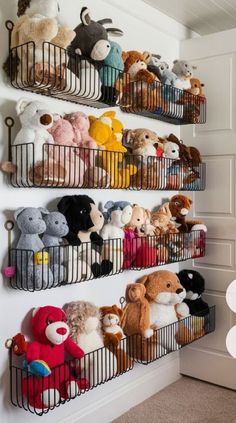 there are many stuffed animals in baskets on the wall