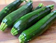 cucumbers are sitting on a cutting board ready to be cut