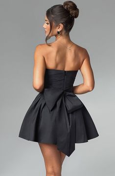 THE dress of the season has landed and you're going to be obsessed. Meet Katrina, our dreamy mini with a pretty, voluminous skirt and waist cinching bodice. Fastening with a zip to the back, tie with an oversized bow to complete the look for perfect feminine drama. 



Colour: Black.

Premium non-stretch cotton blend fabric.

Fully lined.

Strapless ruched bodice with boning.

Waist cinching.

Oversized tie to create bow detail to back.

Voluminous skirt with tulle lining.

Zip fastening to the Chic Pleated Mini Length Corset Dress, Chic Pleated Mini Corset Dress, Pleated Bodice Mini Dress For Prom, Prom Mini Dress With Pleated Bodice, Evening Ruched Bubble Dress, Cocktail Dress With Pleated Waist And Voluminous Skirt, Ruched Mini Length Bubble Dress For Evening, Ruched Mini Bubble Dress For Evening, Chic Dresses With Pleated Bodice And Voluminous Skirt