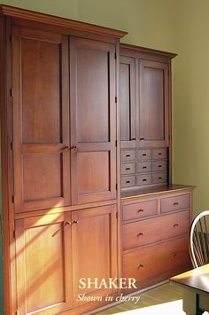 a large wooden cabinet sitting next to a dining room table