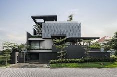 the house is made up of black and white blocks, with trees on each side