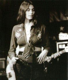 black and white photograph of a woman playing an electric guitar