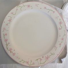 a white plate with pink flowers on it