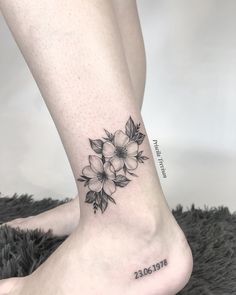 a woman's foot with a flower tattoo on the side of her leg, which reads date 2013