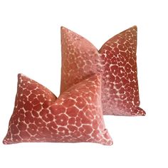 two pink pillows with giraffe print on them