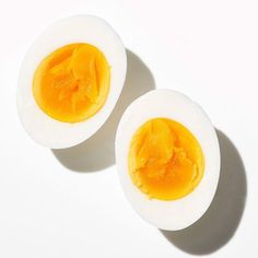 two hard boiled eggs sitting on top of each other