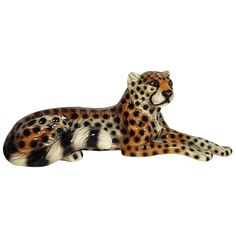 a figurine of a cheetah laying down