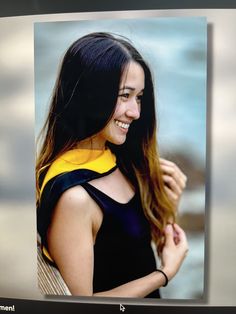 a woman with long hair wearing a yellow and black life jacket